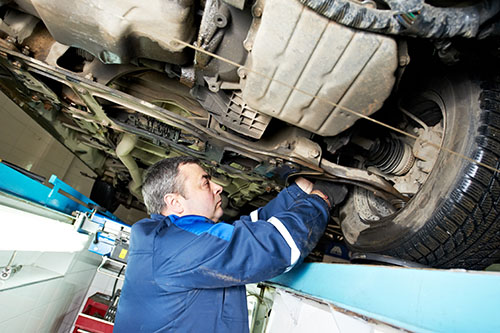 21807478 – auto mechanic at wheel alignment work with spanner